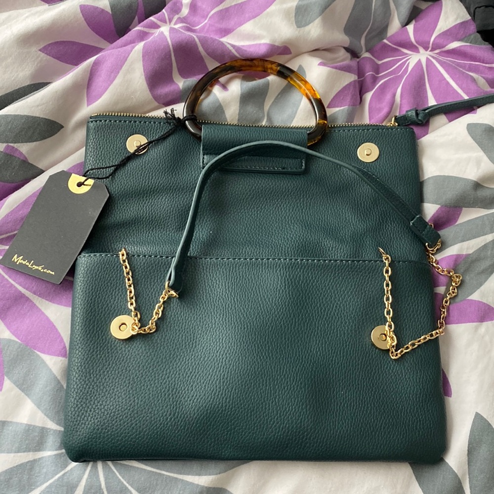 Brand new Moda Luxe hand bag with cross over chain strap.
